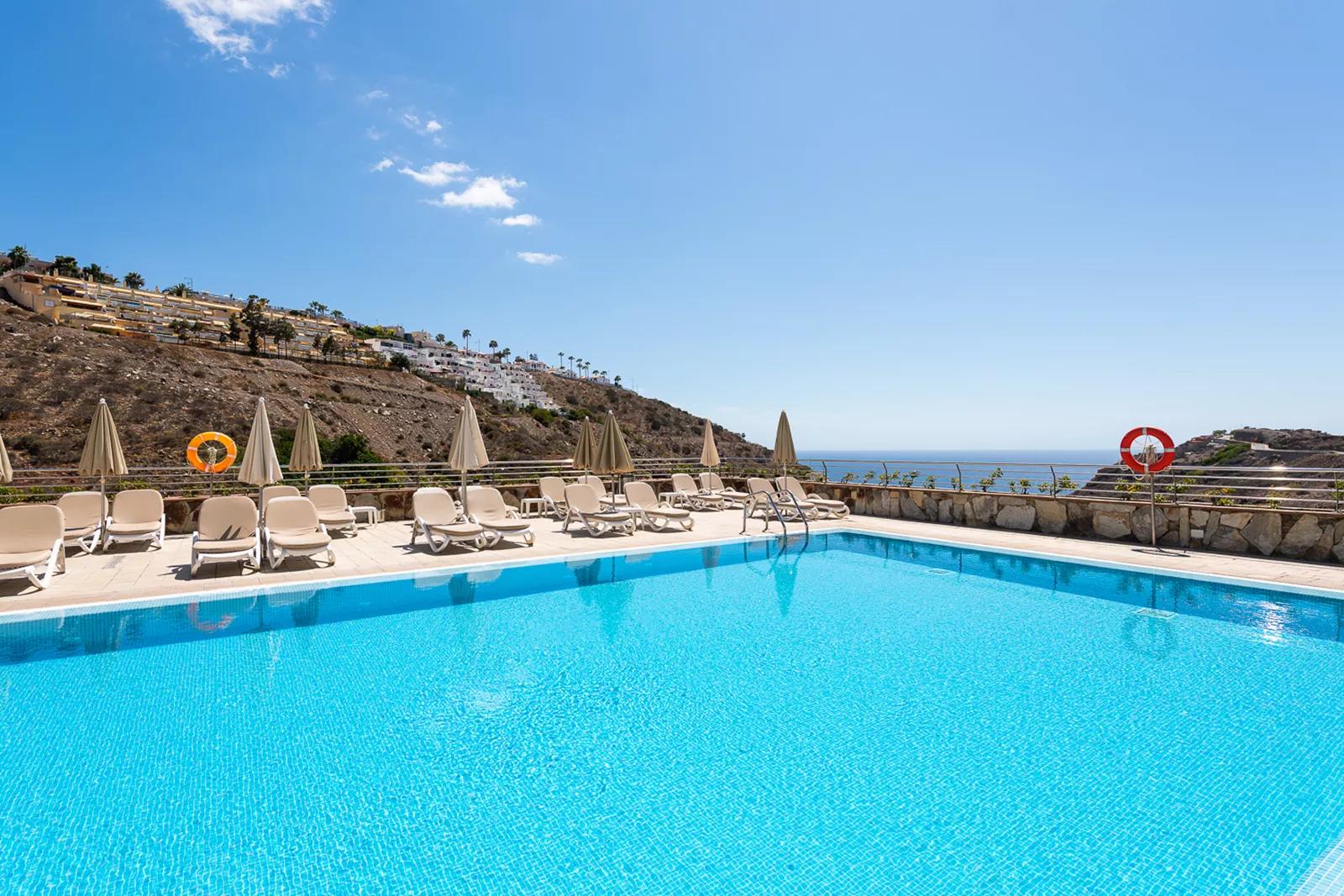 Sol Amadores resort pool overlooking the ocean on Gran Canaria — list and sell timeshare ownership on BidMyTimeshare.com
